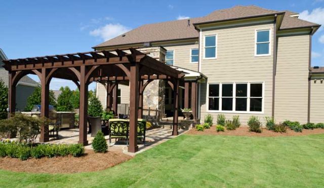 A patio with pergola and kitchen area enhance your outdoor living