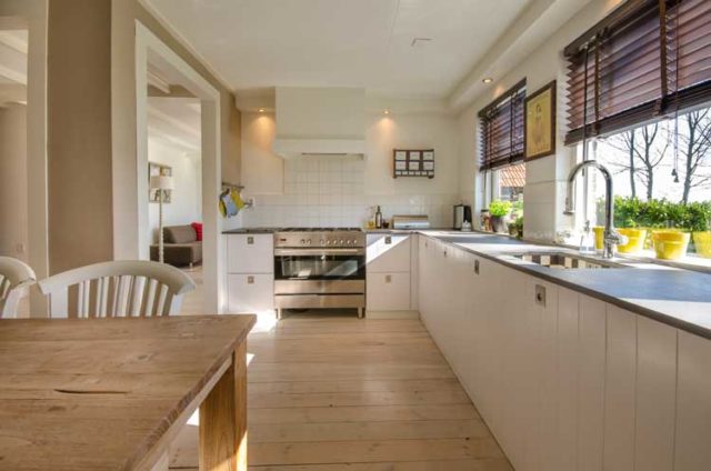 Light-colored floors and walls plus large windows add light to room