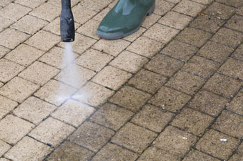 pressure-wash patio bricks and stone