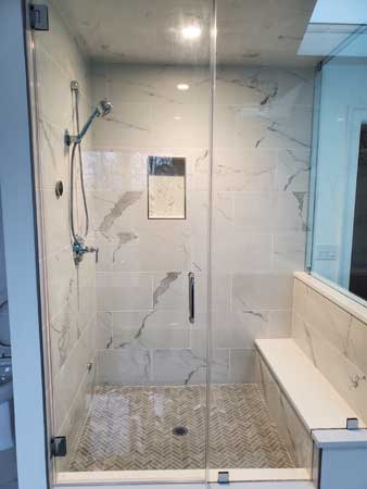 A custom renovated bathroom with a standing shower and a glass door in Mahway, New Jersey.