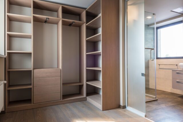 Master Bedroom Walk-In Closet with shelves and mirrors.