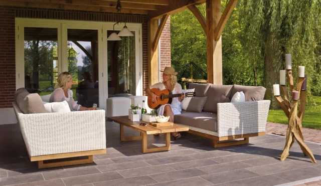 Women sitting outside on a covered deck.